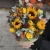 Композиция в сумке "Тональность" из подсолнухов, калл, ягод вибирнума, лимонных роз, скиммии и орхидеи в Раменском